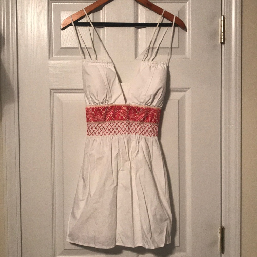 Very pretty white top with red detailed waist.